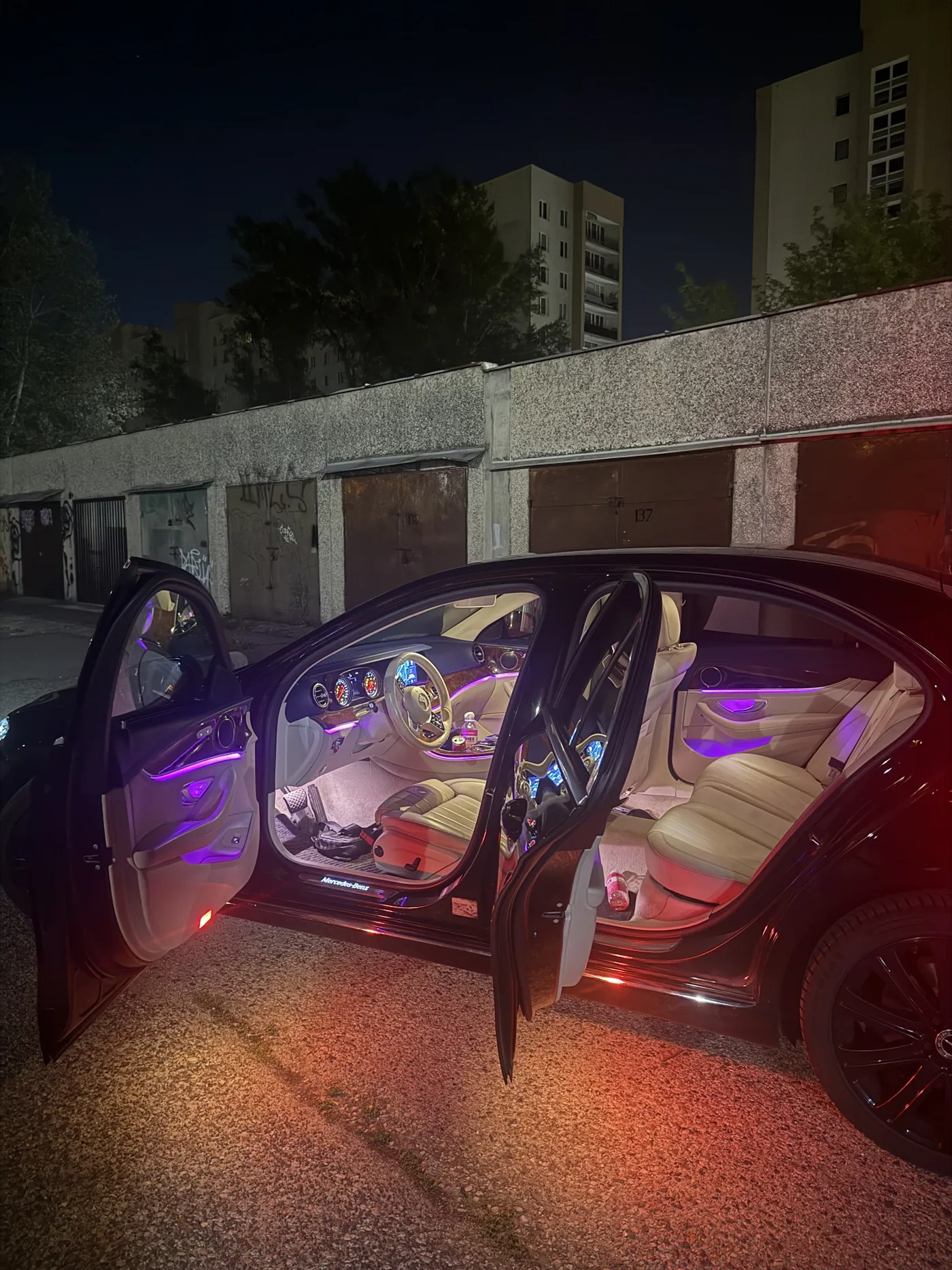 Mercedes at night with purple ambient lighting